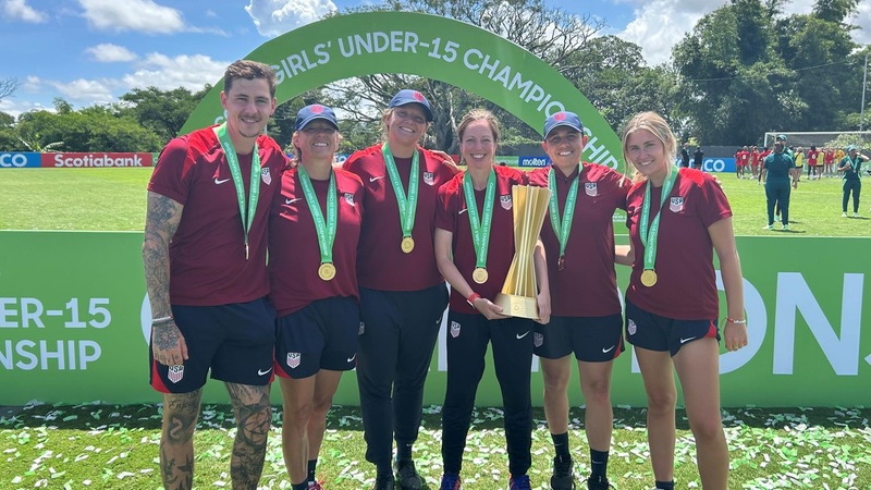 Ciara Crinion '10 (holding trophy), a two-time All-NEC First Team honoree, coached the US girls' U-15 team to the 2024 CONCACAF Championship.